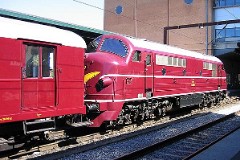 DSB Museumstog MX 1001 photographed in Odense 14. August 2004. The MX class was built by Nydquist & Holm AB (NOHAB) in Sweden licensed by General Motors. It was based on the MY class, but was built with a lower axle load for the Danish branch lines. The MX class was put in service in 1960 - 1962. A1A-A1A. Dieselelectric. 1.445 hp. Max speed 133 km/h - 83 mph. Length 18 300 mm. Weight 89 metric tonnes. Built in a number of 45. MX 1001 was put in service in 1960. Withdrawn from service in 1988 and taken over by the DSB Museumstog. Photographed in Odense during the railwaymuseum's 50th aniversary celebration of the first My class (from General Motors) being put in service in Denmark.